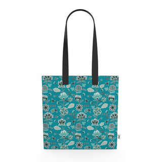 canvas tote with blue and gray flowers on a blue background