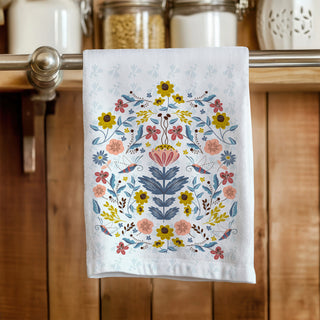 tea towel with illustration of flowers and moths in blues and peach and rust and gold. sold online at jean c studio