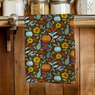 Colorful autumn-themed towel featuring hand drawn illustration of pumpkins and squash and sunflowers. Sold online at JeanC Studio.
