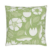 closeup image of a throw pillow. the pillow has a lot of abstract flowers in a palette of cream  and pale green. There are abstract green and white leaves surrounding it. There are also yellow green leaves in the background. The background is a fresh medium green color. It's a very summery or spring pillow cover.
