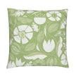 closeup image of a throw pillow. the pillow has a lot of abstract flowers in a palette of cream  and pale green. There are abstract green and white leaves surrounding it. There are also yellow green leaves in the background. The background is a fresh medium green color. It's a very summery or spring pillow cover.
