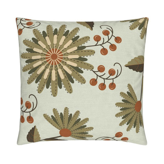 closeup image of a throw pillow. the pillow has several flowers in a light warm green, dark green and white with stylized petals and orange berries. The background is a very pale green.