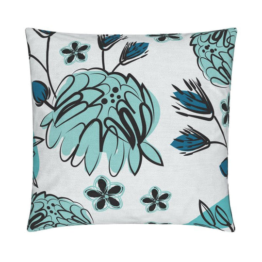 closeup image of a throw pillow. the pillow has light blue stylized peonies and stylized blue and charcoal flowers. Smaller light blue and charcoal flowers are in the white background. The illustration is done in a brushy style.