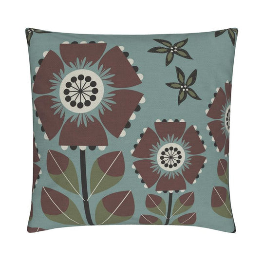 closeup image of a throw pillow. the pillow has a light teal background and 4 stylized brown and white flowers. Smaller dark green and light green flowers are in the background. 