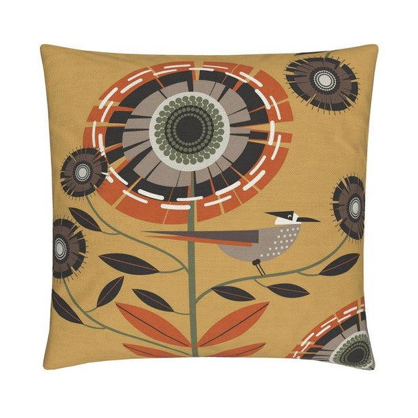 image of a throw pillow. the pillow has a gold background and one large stylized orange and tan flower. There is also a tan and orange bird sitting on a stem. Smaller brown and dark brown flowers surround it. 