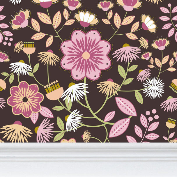 closeup image of wallpaper on a wall featuring stylized large pale  pink and rose flowers and light green and peach colored leaves against a medium warm brown  background