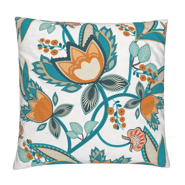 image of a throw pillow with an illustration of large stylized flowers in teal and orange on a pale cream background