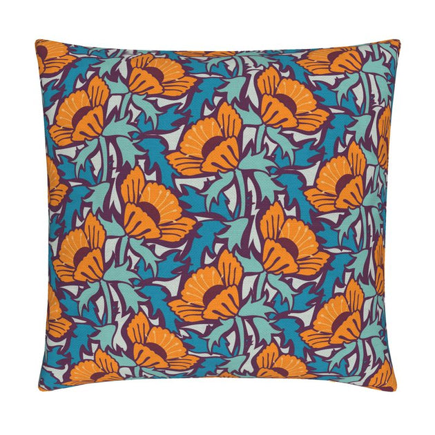 Image of pillow cover featuring bold large poppies in orange, surrounded by blue green leaves, on a dark background.