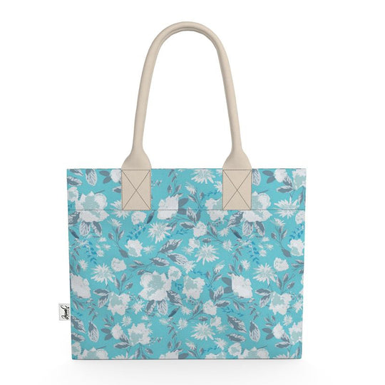 Image of tote bag with very pale blue flowers and grey blue leaves against a medium aqua blue background