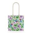 Image of tote bag with purple coneflowers, green and blue leaves against a pale gree background