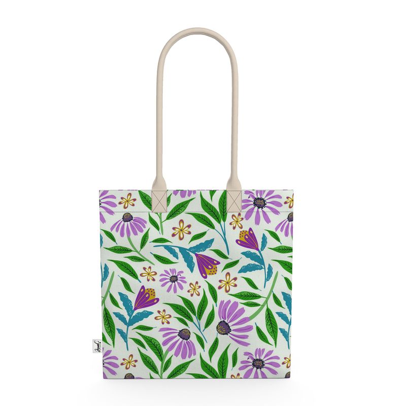 Image of tote bag with purple coneflowers, green and blue leaves against a pale gree background