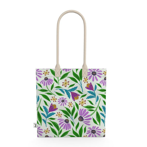 Image of tote bag with purple coneflowers, green and blue leaves against a pale gree background