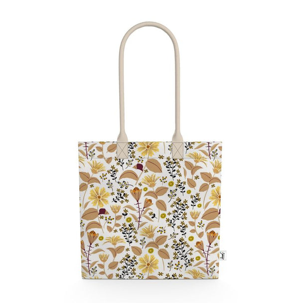 Image of tote bag with yellow flowers and tan and gold leaves against a white background
