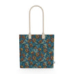 Image of tote bag with bold cocoa and gold colored flowers, teal and gold leaves, gold berries against a medium blue background.