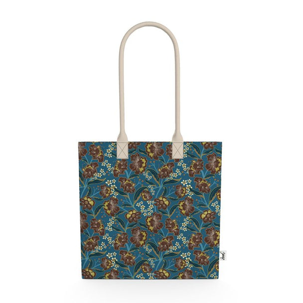 Image of tote bag with bold cocoa and gold colored flowers, teal and gold leaves, gold berries against a medium blue background.