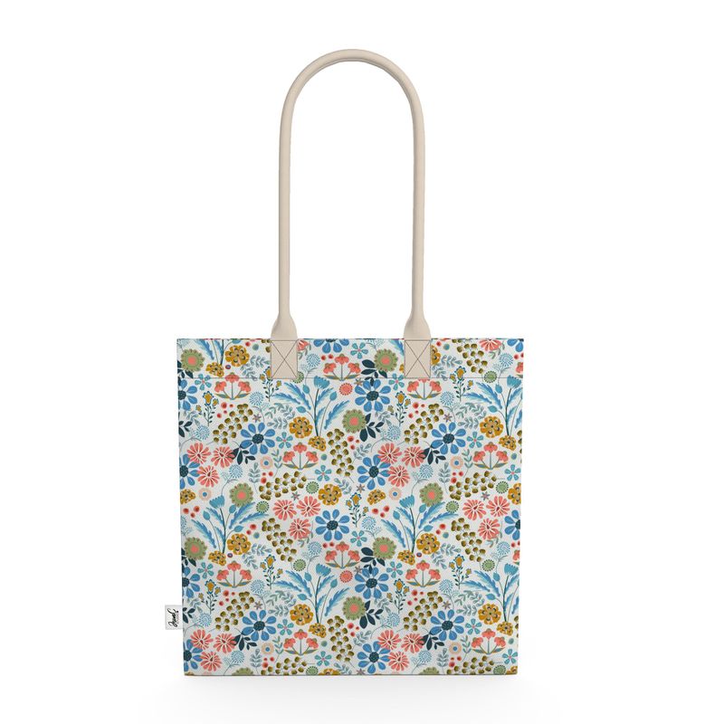 Image of tote bag with flowers in gold, green, blue and orange against a white background.
