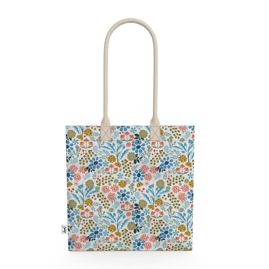 Image of tote bag with flowers in gold, green, blue and orange against a white background.