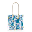 Image of tote bag with stylized blue and gold flowers, blue green leaves and bees