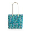 Image of tote bag with abstract flowers in blue, blue green and silver against a medium blue background. Also visible are bees and butterflies.