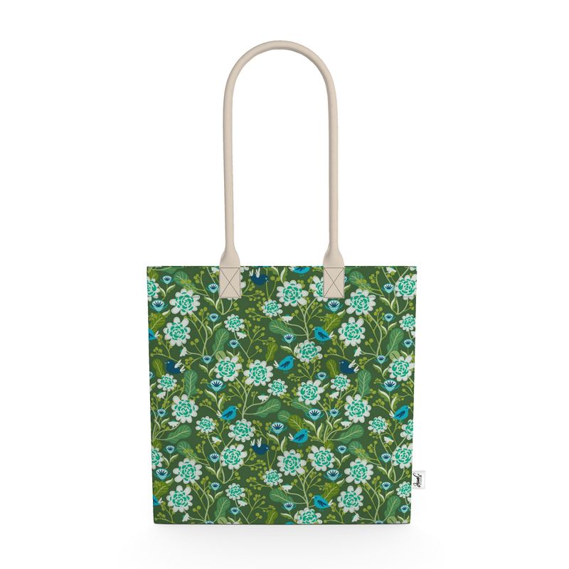 Image of tote bag with hand drawn flowers in pale blue. Also seen are blue birds and leaves.