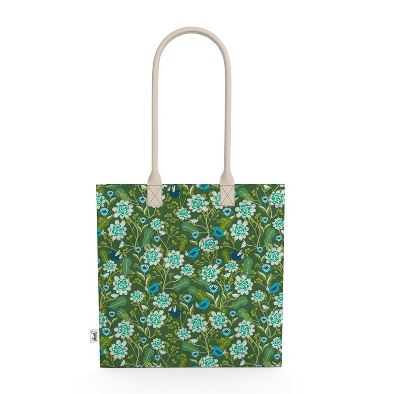 Image of tote bag with hand drawn flowers in pale blue. Also seen are blue birds and leaves.