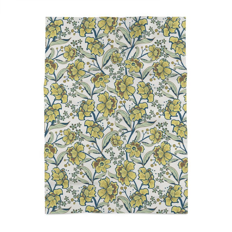 Image of tea towel with yellow flowrs and green leaves in a twining arrangement