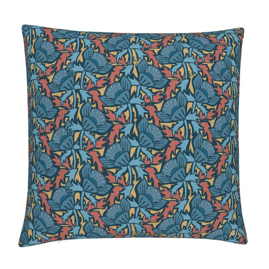 Image of pillow cover with bold blue blossoms and blue and rust colored leaves on a gold background.