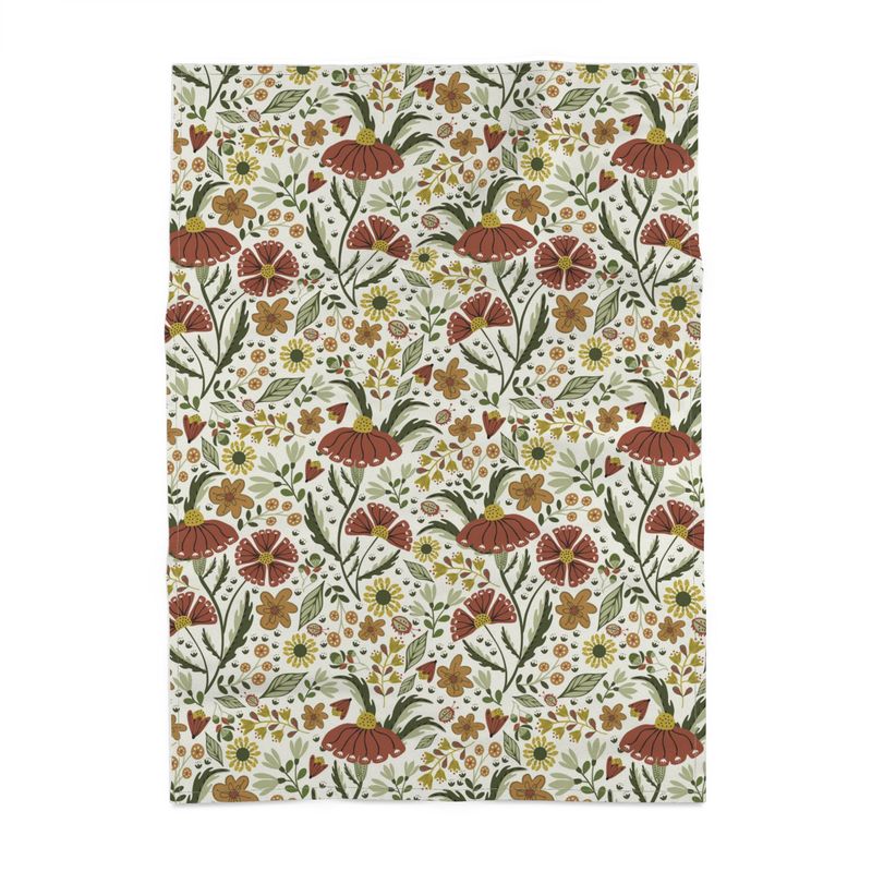 image of tea towel illustrated with flowers and ladybugs in earth tone colors