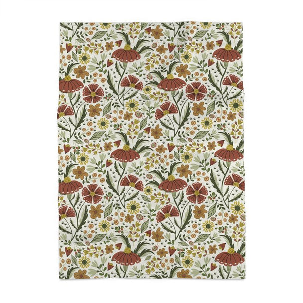 image of tea towel illustrated with flowers and ladybugs in earth tone colors