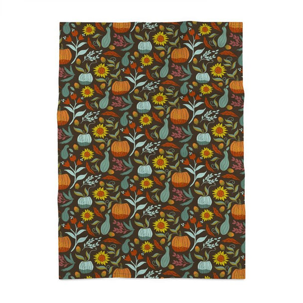 Image of tea towel with pumpkins, sunflowers, berries and leaves.