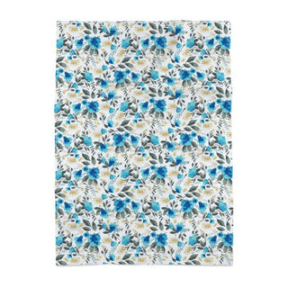 Floral patterned fabric with blue, green, and white flowers on a white background