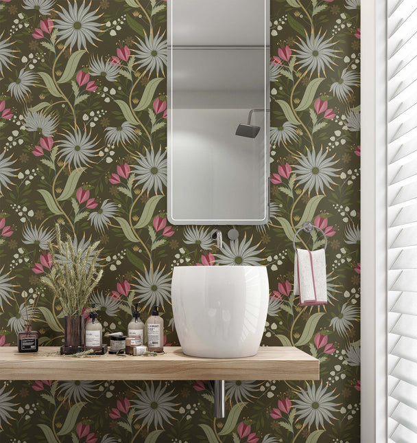 Image of wallpaper on a bathroom wall featuring stylized large blue gray and pink  flowers and light green leaves against a medium dark green  background