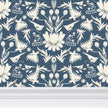 Image of wallpaper closeup featuring stylized large white flowers and birds against a blue gray background