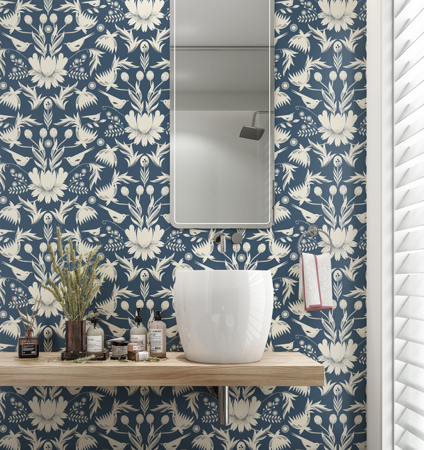 Image of wallpaper on a bathroom wall featuring stylized large white flowers and birds against a blue gray background